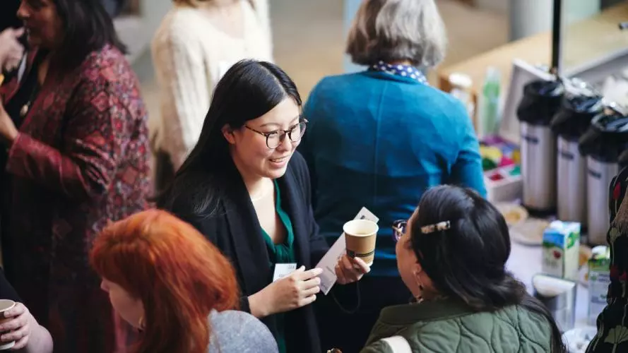 A group of women talking at a conference