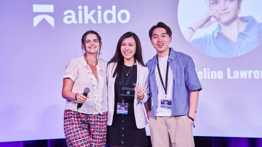Two women and one man standing together 
