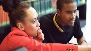 Two students concentrating and working together