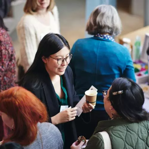 A group of women talking at a conference