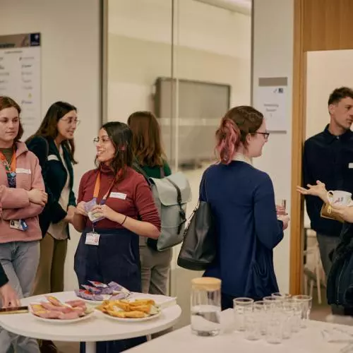 A group of event attendees networking over drinks