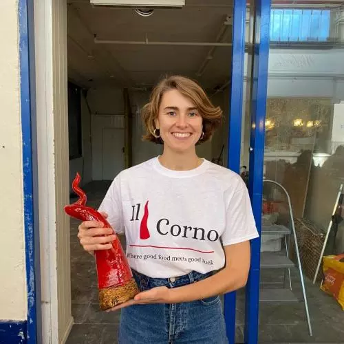 Owner of Il Corno, Fanny Clemente, standing in the new restaurant doorway