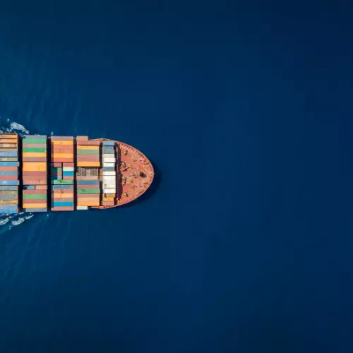 a dron picture of a half of a cargo shipon the left side