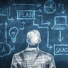 An illustration of a man looking at a chalkboard with idea, success and plan graphics