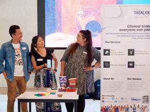 The Trialex startup team chatting together and stood next to their stand