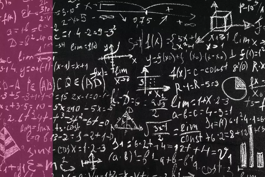 A chalkboard covered in maths calculations and diagrams