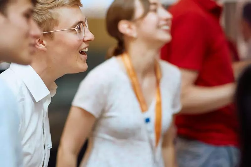 Three students stood at an event laughing