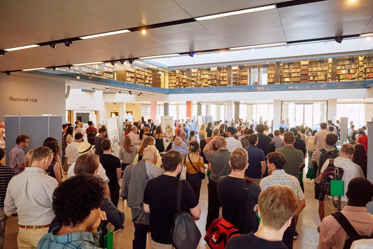 A crowd at an event listening to a speaker