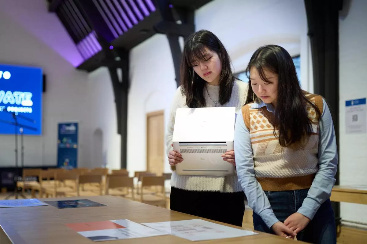 two students looking at printed out business model canvas documents